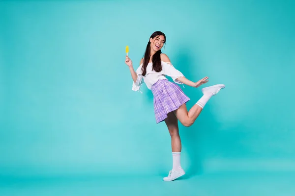 Full body photo of college student learning weekends hold cold dessert popsicle wear long socks isolated cyan color background.