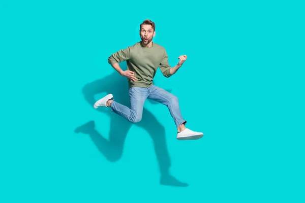 Full length profile photo of inspired sportsman jump play imaginary guitar wear pullover isolated blue color background.