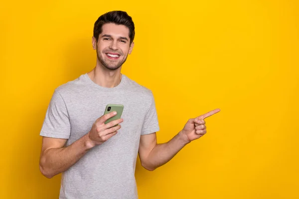 Portrait Attractive Cheerful Guy Using Device Demonstrating Copy Space Isolated — 图库照片