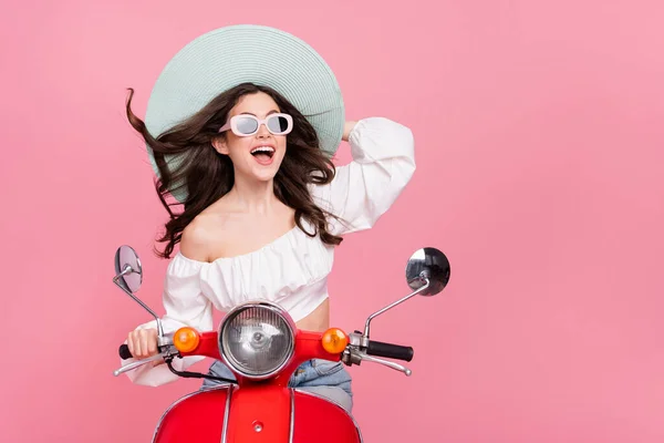 Photo of positive amazed person drive bike enjoy summer vacation isolated on pink color background.