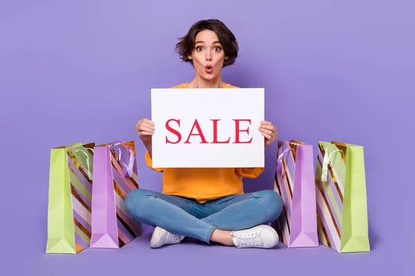 Portrait Attractive Amazed Girl Holding Sale Board Sitting Lotus Pose — 스톡 사진