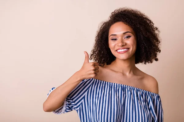 Portrait of pretty friendly person hand finger demonstrate thumb up isolated on beige color background.