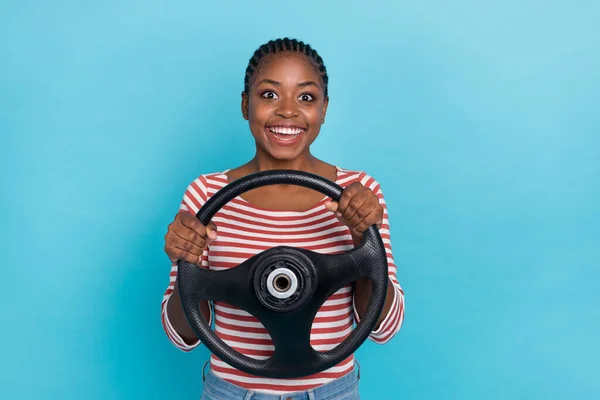 Photo of excited funny person arms hold wheel toothy smile wear red white isolated on blue color background.