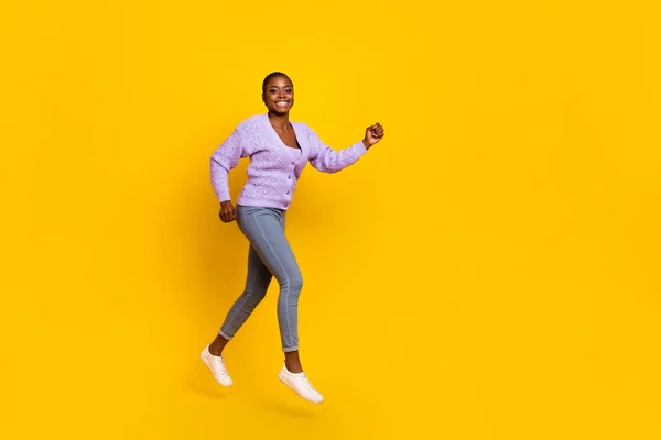 Full size profile photo of overjoyed energetic person running empty space isolated on yellow color background.