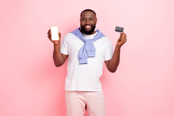 Photo of young stylish wealthy man use wireless transactions to buy online shop isolated on pink color background.