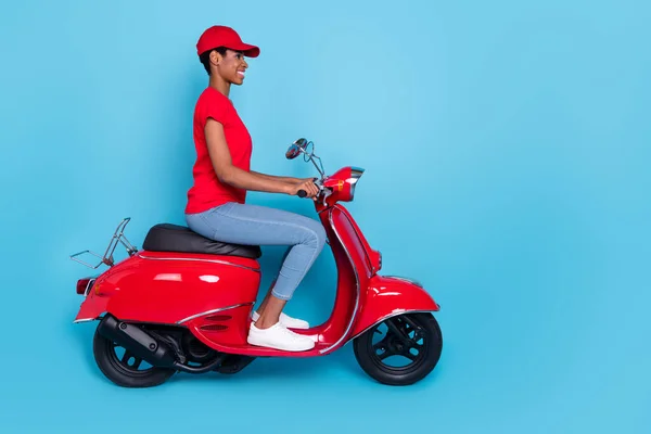 Photo of cute cheerful short hair person dressed red uniform moto rider looking empty space isolated blue color background.