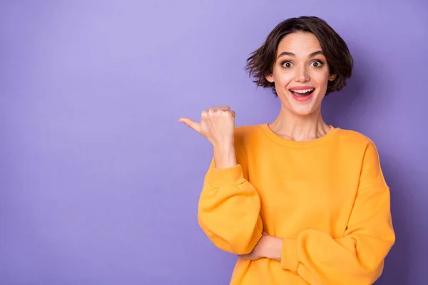 Photo Excited Positive Lady Indicate Thumb Finger Empty Space Blank — Stockfoto