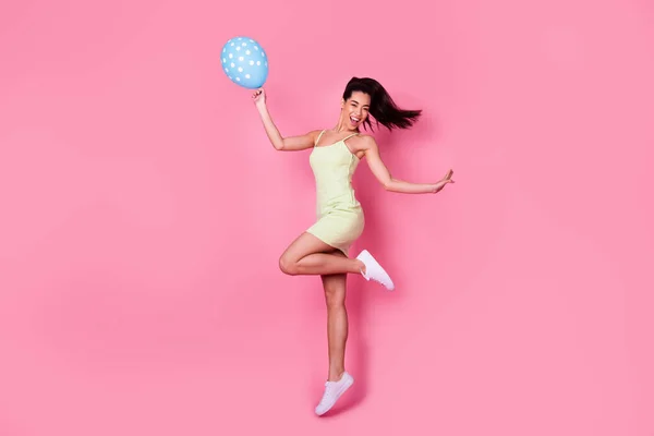 Full length photo of excited lady jump catch hold air balloon wear stylish short skirt isolated pastel color background.