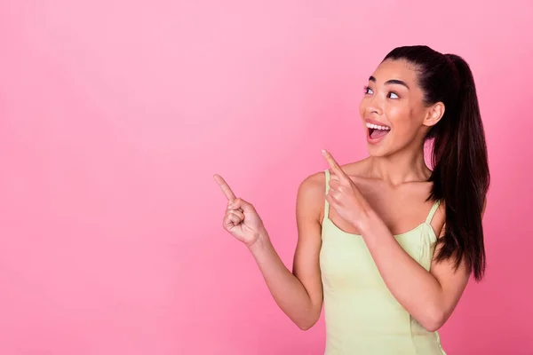 Photo of excited lady point empty space indicate wow incredible discount isolated pastel color background.