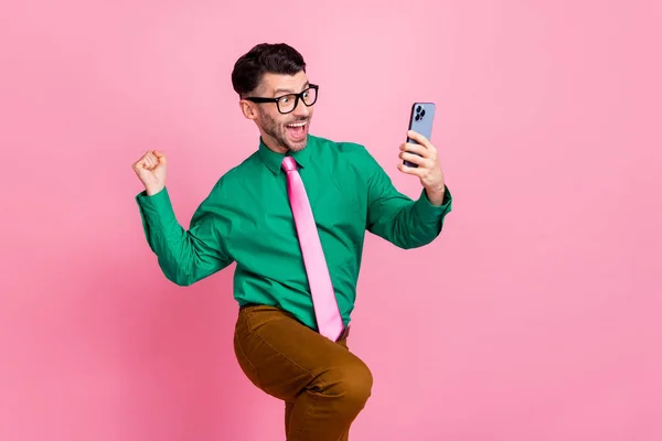 Photo of amazed lucky man dressed green shirt eyewear gambling esport modern gadget isolated pink color background.