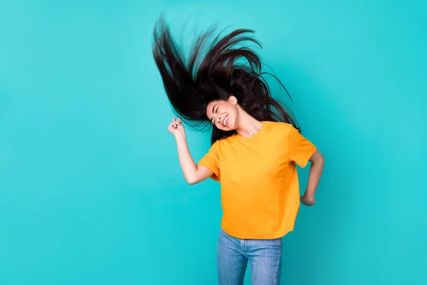 Photo of hooray brunette lady dance hair up wear orange t-shirt isolated on teal color background.