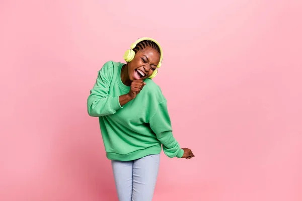 Photo of excited overjoyed person listen music sing favorite track isolated on pink color background.