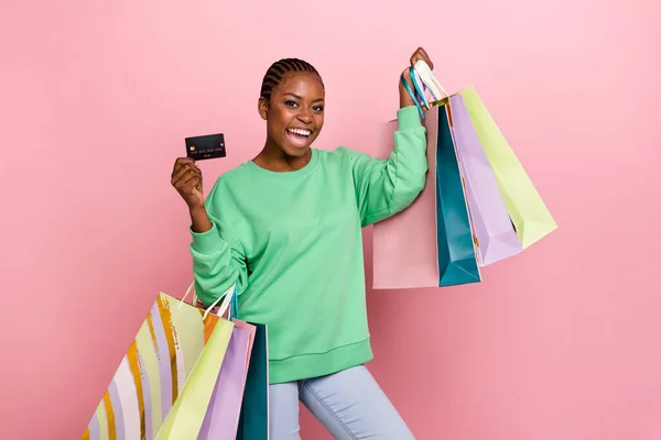 Photo of funny positive lady hold packages debit plastic card isolated on pink color background.