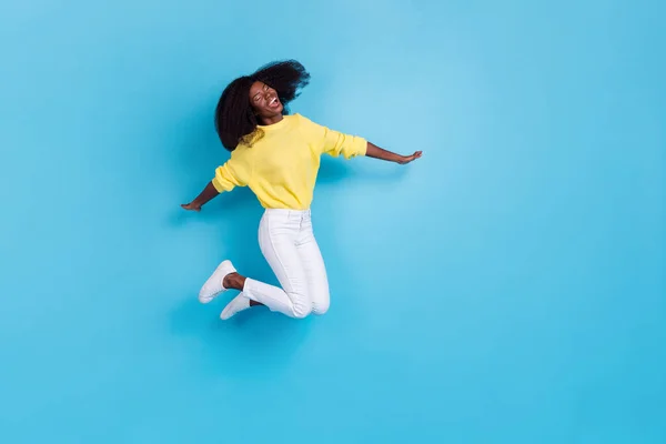 Full size body photo of young crazy excited lady jump happy new summer season playlist spotify isolated on blue color background.