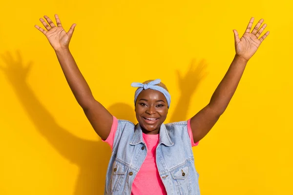 Portrait of cheerful excited person raise opened arms toothy smile isolated on yellow color background.