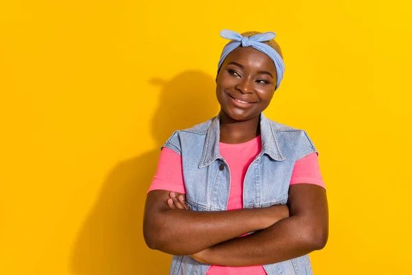 Portrait of funky satisfied person folded hands look interested empty space isolated on yellow color background.