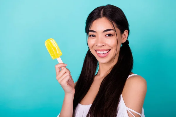 Photo of pretty lovely lady enjoy summer holiday hold delicious fruity refreshment popsicle isolated cyan color background.