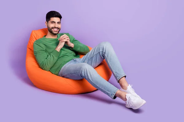 Full Size Photo Young Latin Man Sit Comfy Beanbag Hold — Foto Stock