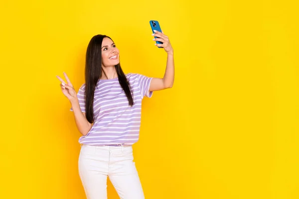 Photo of pretty charming lady hand arm hold telephone show followers hello greetings symbol empty space isolated on yellow color background.