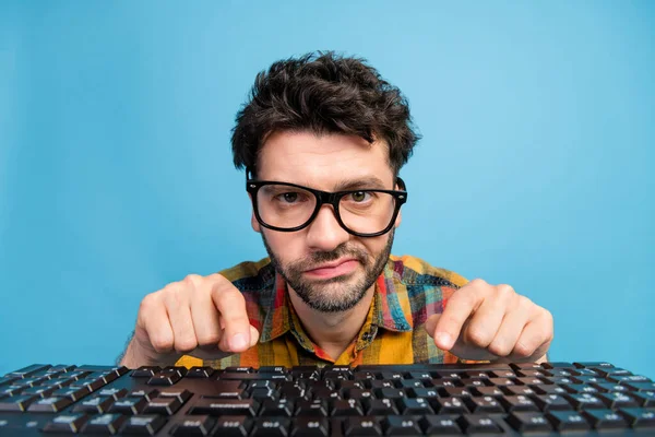 Photo of unhappy brunet guy type keyboard wear eyewear plaid shirt isolated on blue color background.