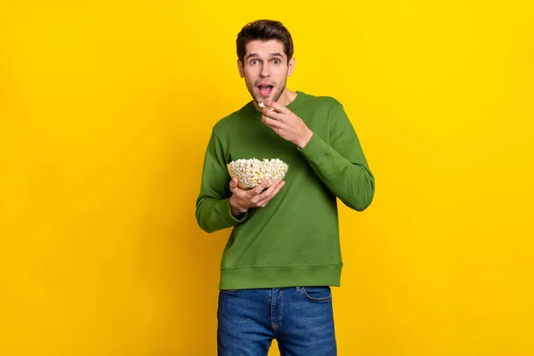 Photo Positive Impressed Young Guy Wear Green Sweater Eating Tasty — Stockfoto