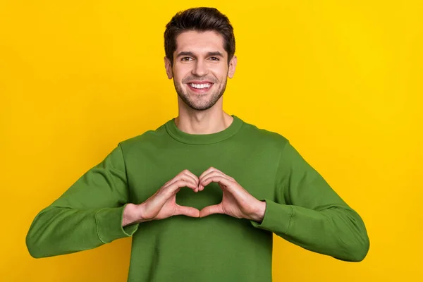 Photo Pretty Charming Guy Dressed Green Pullover Showing Arms Heart — Stock fotografie