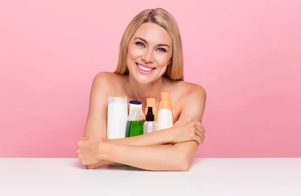 Photo of joyful lady hug all beauty new products for pure ideal skin wear top isolated over pink pastel color background.