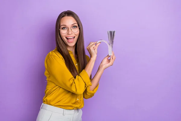 Photo of impressed young lady count money wear eyewear blouse isolated on violet color background.