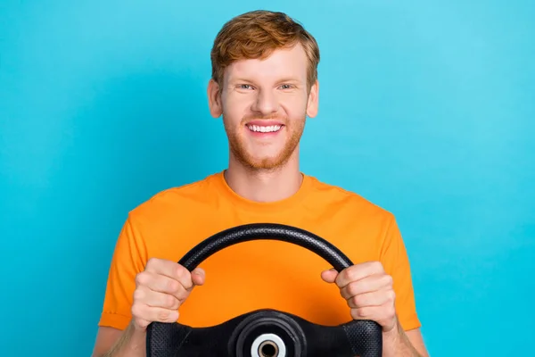 Photo of hooray ginger hair guy drive car wear orange t-shirt isolated on teal color background.