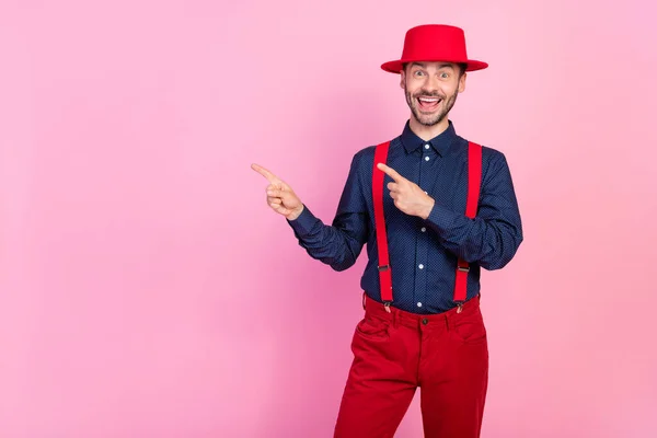 Photo of cheerful excited person indicate fingers empty space proposition isolated on pink color background.