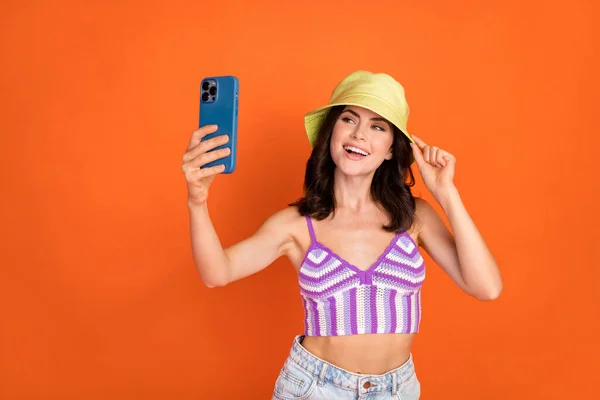 Photo Brunette Impressed Lady Selfie Wear Hat Top Isolated Orange — Stok fotoğraf
