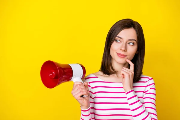 Photo of pretty minded mischief lady arm hold megaphone look blank space has creative idea plan isolated on yellow color background.