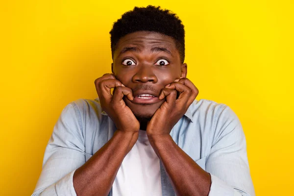 Portrait of shocked guy look nightmare bite nails feel scared isolated shine vibrant color background.