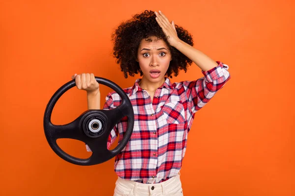 Photo of young stressed wavy lady drive car wear red shirt isolated on orange color background.