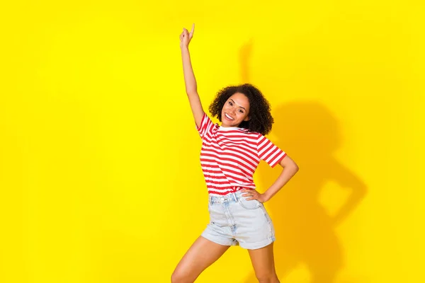 Photo of brunette funky lady dance wear red t-shirt shorts isolated on vivid yellow color background.