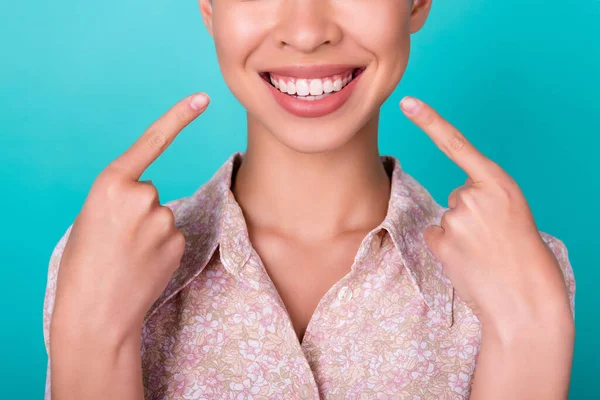 Close up cropped half face portrait of cheerful korean girl point ideal healthy white teeth dressed shirt isolated on cyan color background.