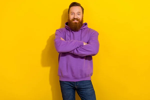 Photo of young positive clever businessman with folded arms wear comfy hoodie isolated on yellow color background.