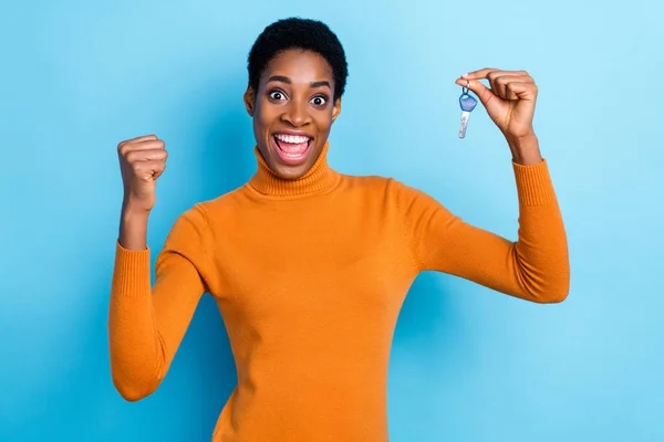 Photo of amazed astonished funky lady rejoice attainment wear yellow turtleneck isolated blue color background