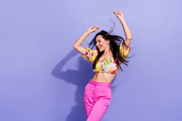 Photo of pretty funky lady wear yellow crop top dancing air blowing isolated violet color background.