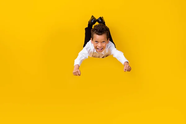 Full size portrait of overjoyed positive person falling have good mood isolated on yellow color background.