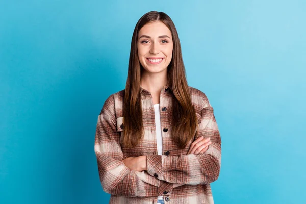 Photo of gorgeous satisfied person toothy beaming smile crossed hands isolated on blue color background.