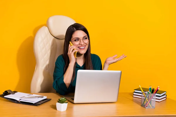 Photo of young cheerful woman listen say speak communication mobile manager isolated over yellow color background.