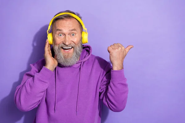 Portrait Healthy Pensioner Man Purple Hoodie Touch Headphones Directing Empty — Stock Photo, Image