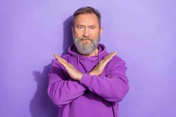 引退したハンサムな深刻な不幸な男の服を着た紫色のパーカー立ち保持腕折り畳まれた孤立した紫色の背景 — ストック写真