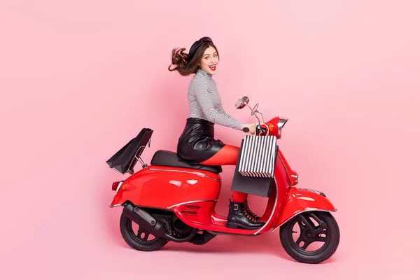 Profile side photo of extreme motor bike vehicle lady driver ride store stylish buyings offer isolated pink color background.