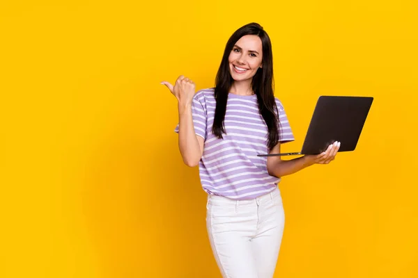 Photo of charming positive lady arm direct empty space offer quality cool modern device gadget netbook isolated on yellow color background.