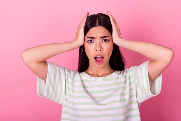 Portrait of confused speechless filipino person hands touch head open mouth isolated on pink color background.