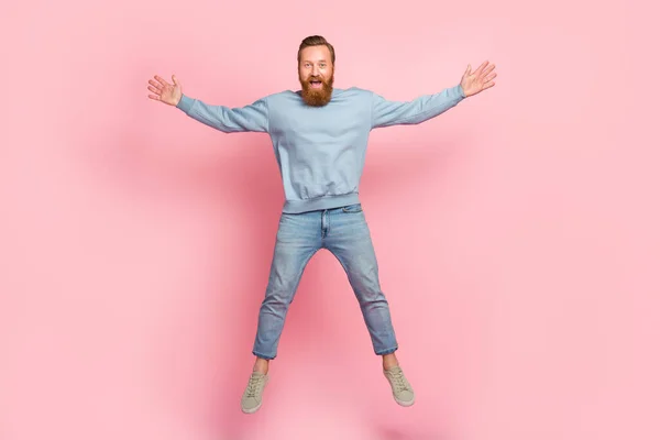 Full body portrait of overjoyed satisfied person jumping male star figure isolated on pink color background.