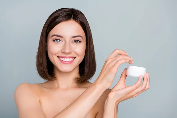 Photo of joyful positive lady hold cream jar want apply face silky wellness skin effect isolated over grey color background.