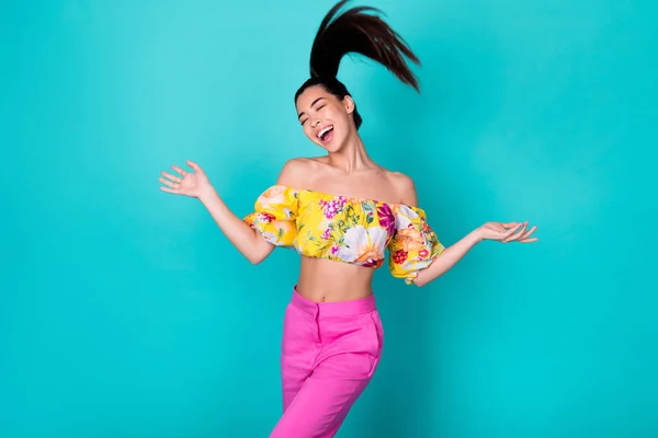 Photo of sweet young lady dance wear yellow top pink pants isolated on teal color background.